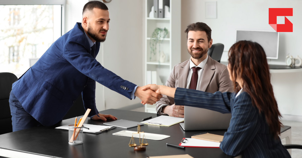Professionals in a conference room shaking hands