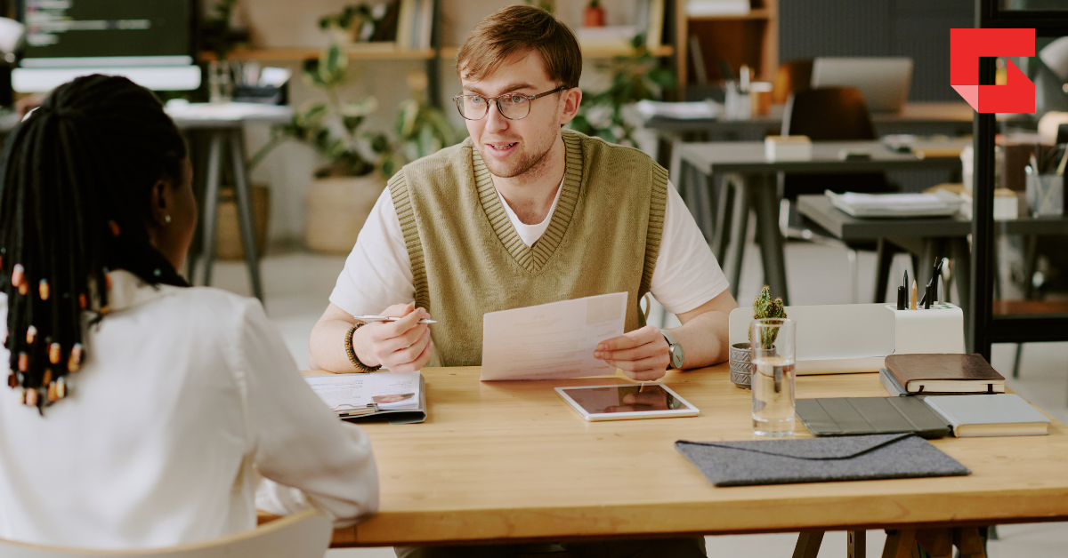 Man interviewing a woman for a job