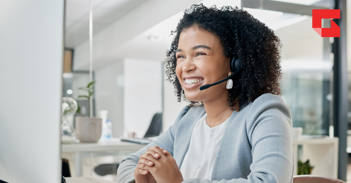 woman smiling while working at a computer
