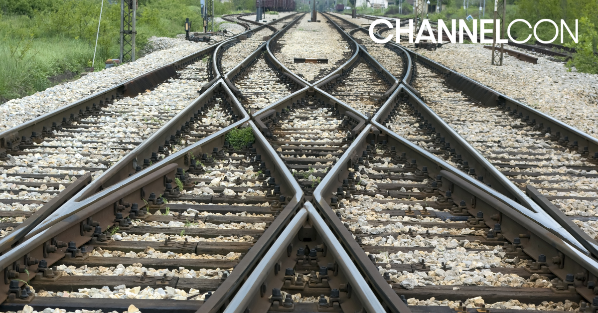 Railroad tracks converging into one path
