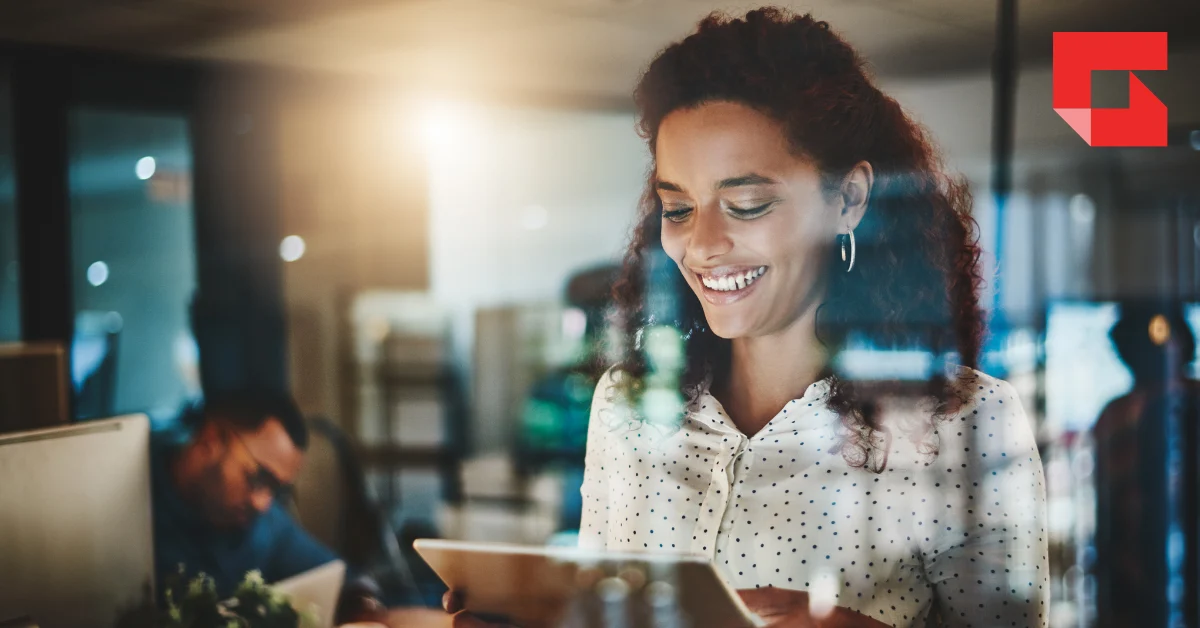 Woman smiling looking at a tablet device