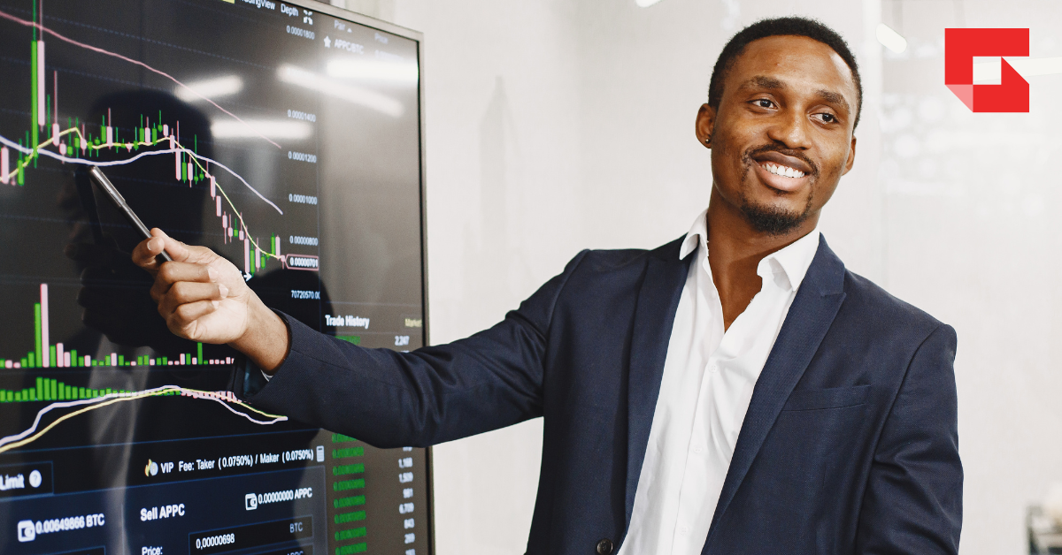 Man pointing to a graph on a large screen