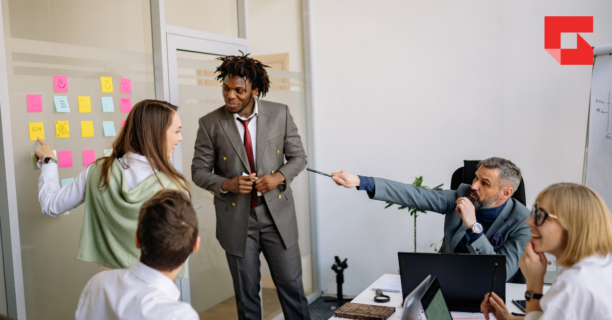 group of co-workers talking in a meeting room
