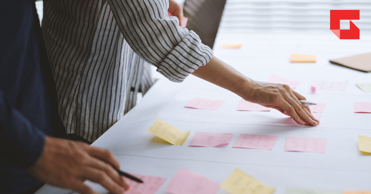 Handing organizing post it notes on a table