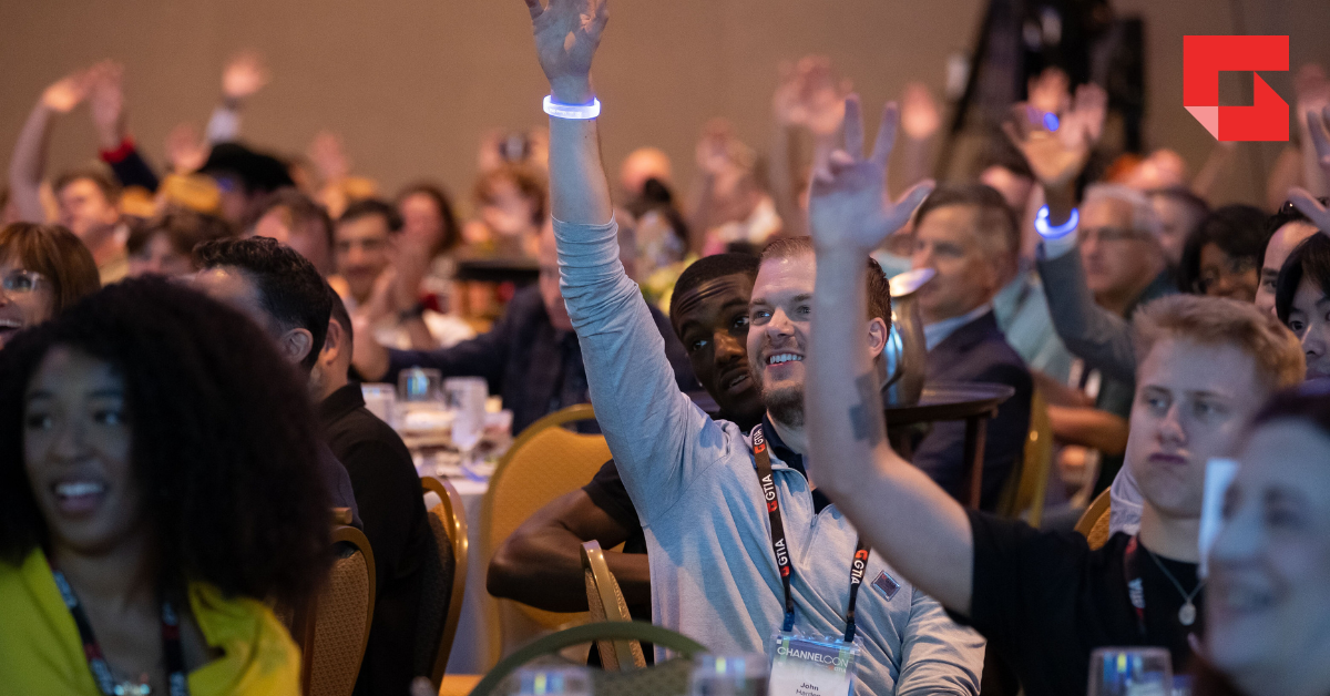 Group of people raising their hands at ChannelCon