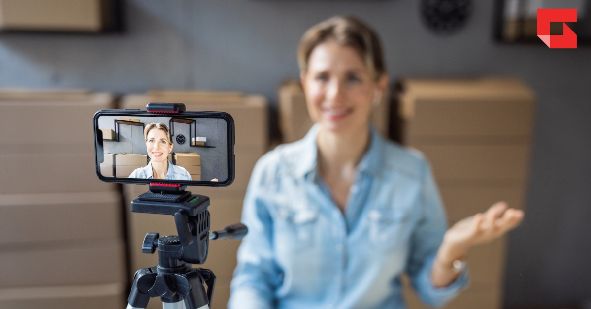 A woman recording a video of herself on her smart phone.